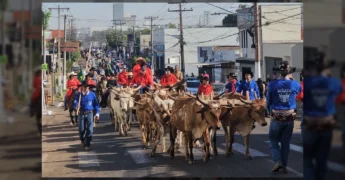 Imagem aérea da 37ª Cavalgada da Exposul em Rondonópolis, com cavaleiros e carros de boi desfilando, créditos a @visiterondonopolis no Instagram.