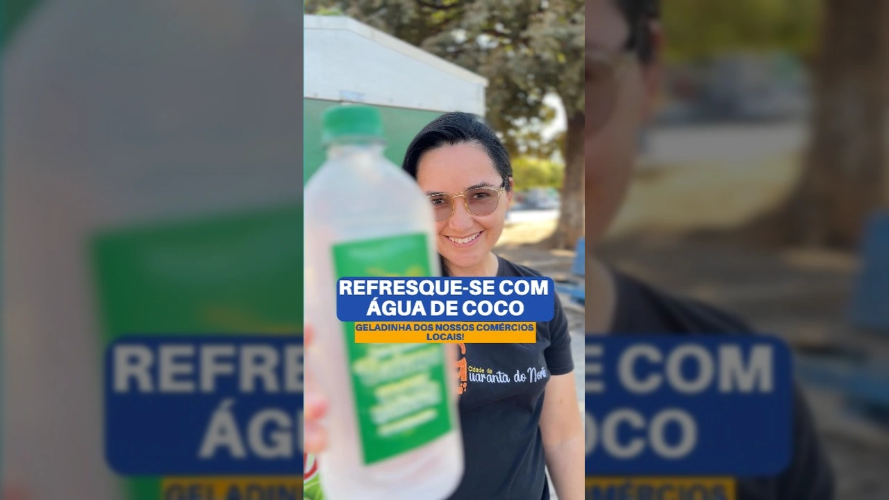 Foto de uma mulher bebendo água de coco, com o banner da 'Água do Baiano' ao fundo, promovendo produto local em Guarantã do Norte. Créditos: Prefeitura Municipal.