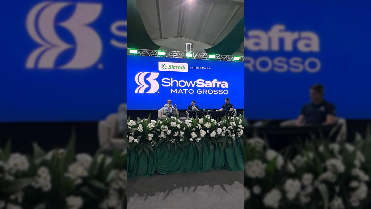 Joci Piccini em palco do lançamento do Show Safra Mato Grosso 2026 em Lucas do Rio Verde, com telão exibindo o logo do evento e o nome Sicredi. Créditos: Joci Piccini / Instagram