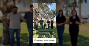 Grupo de cinco pessoas à frente de um prédio sob palmeiras, anunciando o Cine Cultura. Créditos: Prefeitura Municipal de Nova Ubiratã / Instagram.