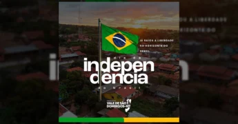 Imagem da bandeira do Brasil tremulando ao pôr do sol em Vale de São Domingos, com casas ao fundo, em homenagem ao Dia da Independência. Créditos: Prefeitura Municipal de Vale de São Domingos / Instagram