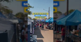 Imagem da repórter na Feira do São Domingos, em Sorriso, segurando um pastel e caldo de cana. Créditos: Prefeitura de Sorriso / Instagram